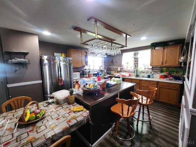 223 Park St, Middletown, OH 45044 - kitchen featuring freestanding refrigerator, brown cabinetry, white microwave, light countertops, and recessed lighting