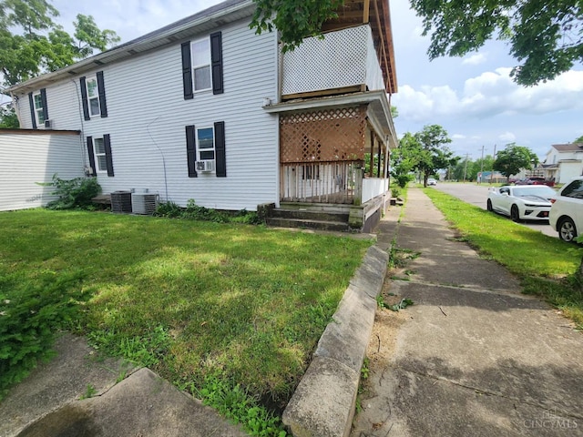 223 Park St, Middletown, OH 45044 - rear view of house featuring central AC unit, a lawn, and cooling unit