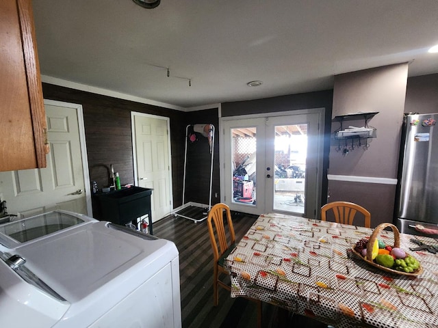 223 Park St, Middletown, OH 45044 - kitchen with freestanding refrigerator, french doors, dark wood-style floors, light countertops, and wooden walls