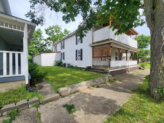 223 Park St, Middletown, OH 45044 - view of side of home featuring a yard, a porch, and a balcony