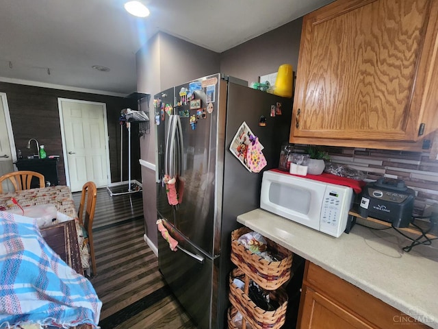 223 Park St, Middletown, OH 45044 - kitchen with white microwave, freestanding refrigerator, light countertops, brown cabinets, and baseboards