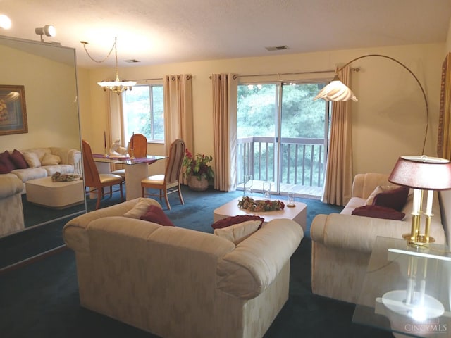 5292 Eaglesnest Dr Unit 41, Green Twp, OH 45248 - carpeted living area featuring a chandelier