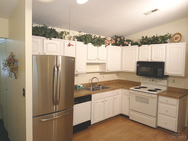 5292 Eaglesnest Dr Unit 41, Green Twp, OH 45248 - kitchen with white appliances, a sink, wood finished floors, and white cabinetry