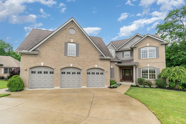 3190 Fox Run Dr, Ross Twp, OH 45013 - view of front of home with driveway, brick siding, a front lawn, and an attached garage
