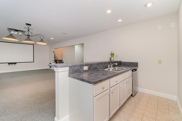 3190 Fox Run Dr, Ross Twp, OH 45013 - kitchen featuring a peninsula, white cabinets, dark countertops, recessed lighting, and decorative light fixtures
