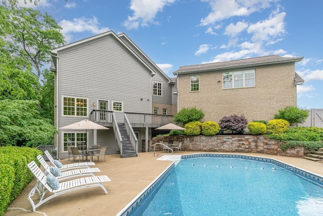 3190 Fox Run Dr, Ross Twp, OH 45013 - swimming pool featuring stairs, outdoor dining area, a wooden deck, and a patio area