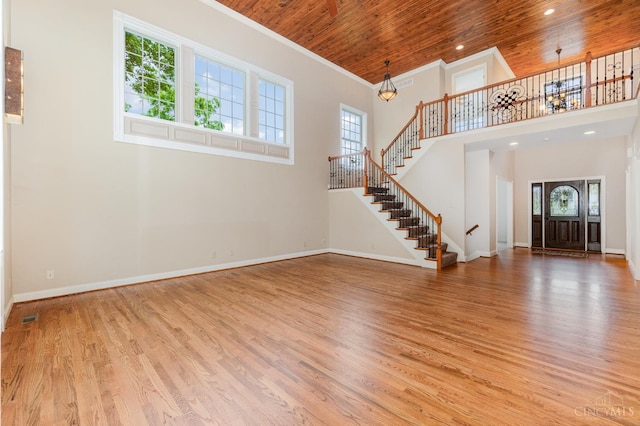 3190 Fox Run Dr, Ross Twp, OH 45013 - unfurnished living room with stairway, wood ceiling, a towering ceiling, wood finished floors, and ornamental molding