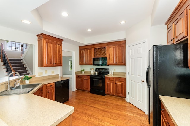 3190 Fox Run Dr, Ross Twp, OH 45013 - kitchen featuring black appliances, recessed lighting, light countertops, light wood-style flooring, and a peninsula