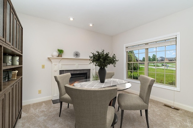 3190 Fox Run Dr, Ross Twp, OH 45013 - dining area featuring light carpet and a glass covered fireplace