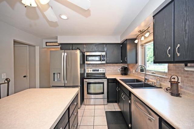 3430 Melodymanor Dr, Colerain Twp, OH 45239 - kitchen with stainless steel appliances, light tile patterned floors, decorative backsplash, light countertops, and ceiling fan