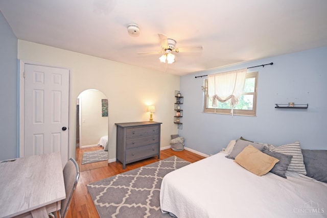 3430 Melodymanor Dr, Colerain Twp, OH 45239 - bedroom featuring arched walkways, wood finished floors, and ceiling fan