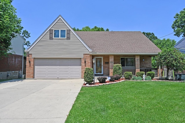 3430 Melodymanor Dr, Colerain Twp, OH 45239 - view of front of house with a front yard, brick siding, driveway, a porch, and roof with shingles