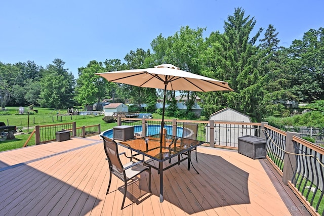 3430 Melodymanor Dr, Colerain Twp, OH 45239 - wooden deck with outdoor dining space, a yard, and an outbuilding