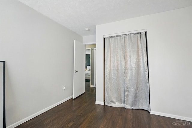 5711 Clemens Dr, Goshen Twp, OH 45140 - unfurnished bedroom featuring wood finished floors, baseboards, and a closet