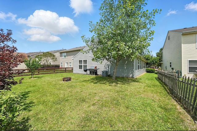 5711 Clemens Dr, Goshen Twp, OH 45140 - view of yard featuring an outdoor fire pit and central AC unit