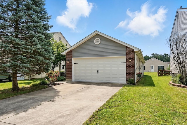 5711 Clemens Dr, Goshen Twp, OH 45140 - view of property exterior featuring a garage, a lawn, and brick siding
