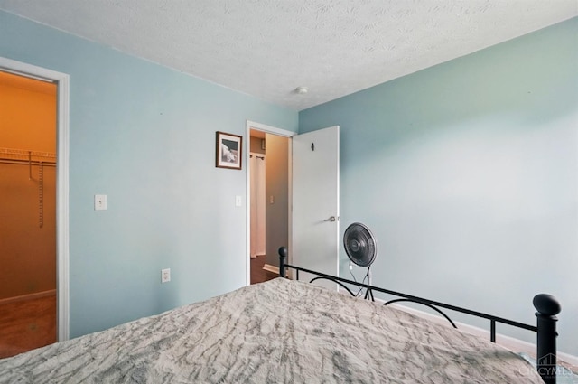 5711 Clemens Dr, Goshen Twp, OH 45140 - bedroom featuring baseboards and a textured ceiling