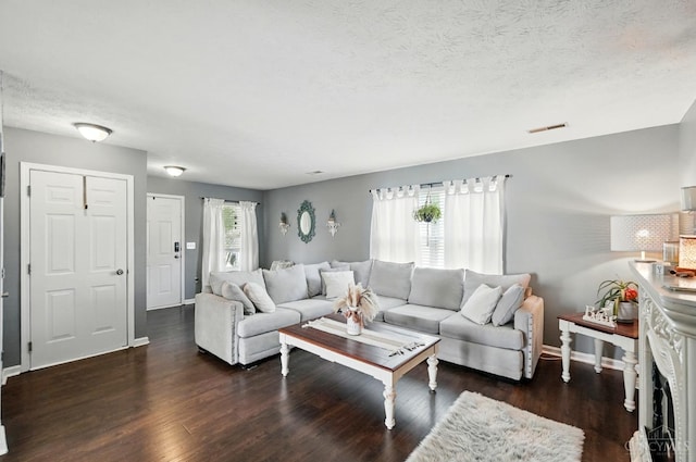 5711 Clemens Dr, Goshen Twp, OH 45140 - living area featuring wood finished floors, baseboards, and a textured ceiling