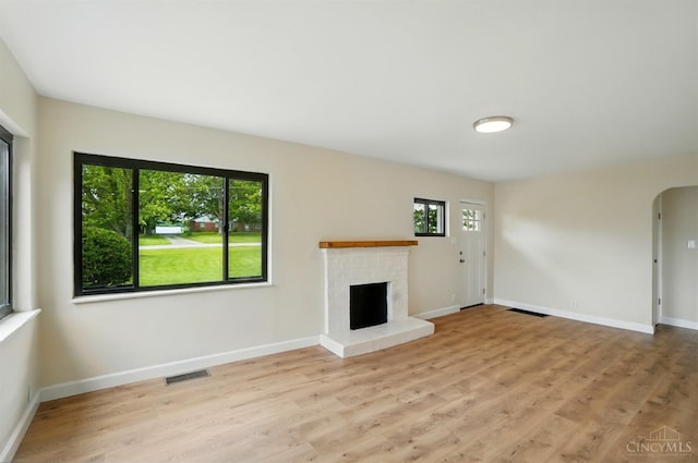 3779 Hopper Hill Rd, Pierce Twp, OH 45255 - unfurnished living room featuring arched walkways, wood finished floors, a fireplace, and baseboards