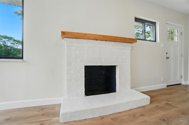 3779 Hopper Hill Rd, Pierce Twp, OH 45255 - detailed view of baseboards, wood finished floors, and a brick fireplace