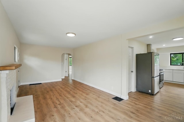 3779 Hopper Hill Rd, Pierce Twp, OH 45255 - unfurnished living room featuring arched walkways, light wood finished floors, and baseboards