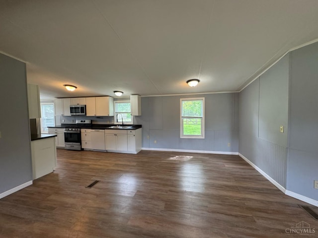 46 Frazier Rd, Jefferson Twp, OH 45148 - kitchen with stainless steel appliances, dark countertops, a sink, dark wood finished floors, and white cabinets