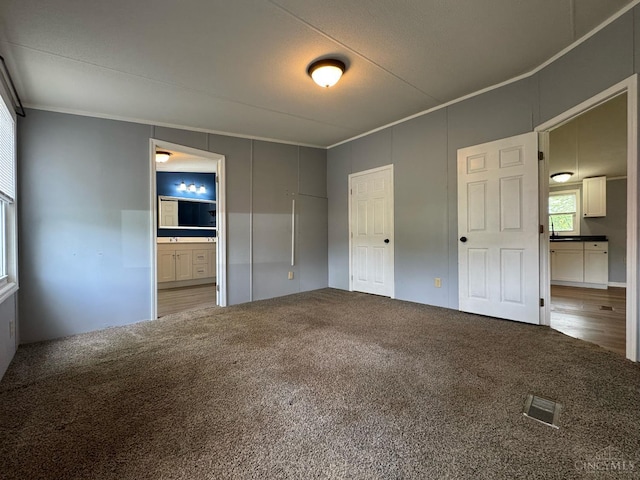 46 Frazier Rd, Jefferson Twp, OH 45148 - unfurnished bedroom with carpet floors, crown molding, and connected bathroom