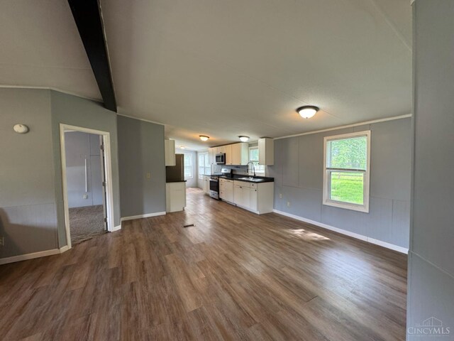 46 Frazier Rd, Jefferson Twp, OH 45148 - unfurnished living room with dark wood-style flooring, baseboards, and beamed ceiling