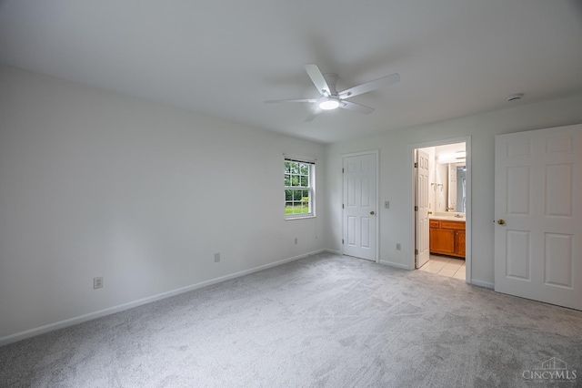 3721 W Galbraith Rd Unit A-2, Cincinnati, OH 45247 - unfurnished bedroom featuring light carpet, baseboards, ensuite bathroom, and a ceiling fan