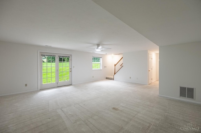 3721 W Galbraith Rd Unit A-2, Cincinnati, OH 45247 - empty room with stairs, a ceiling fan, light colored carpet, and baseboards