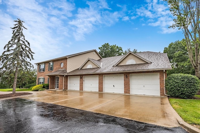 3721 W Galbraith Rd Unit A-2, Cincinnati, OH 45247 - view of front of property with brick siding, concrete driveway, a garage, and a shingled roof