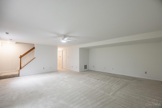 3721 W Galbraith Rd Unit A-2, Cincinnati, OH 45247 - unfurnished living room featuring ceiling fan, stairway, light colored carpet, and baseboards