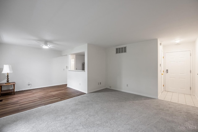 3721 W Galbraith Rd Unit A-2, Cincinnati, OH 45247 - unfurnished living room featuring carpet, a ceiling fan, and baseboards