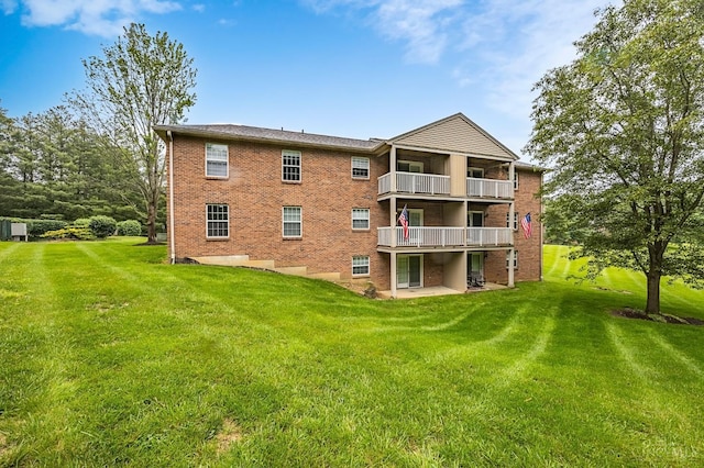 3721 W Galbraith Rd Unit A-2, Cincinnati, OH 45247 - back of house featuring a balcony, a lawn, brick siding, and a patio