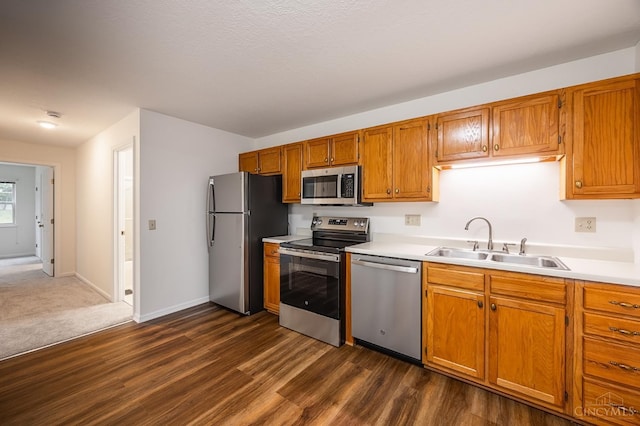 3721 W Galbraith Rd Unit A-2, Cincinnati, OH 45247 - kitchen featuring stainless steel appliances, a sink, light countertops, and dark wood-style flooring