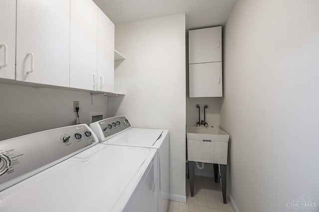 3721 W Galbraith Rd Unit A-2, Cincinnati, OH 45247 - washroom featuring cabinet space, washer and dryer, baseboards, and light tile patterned flooring