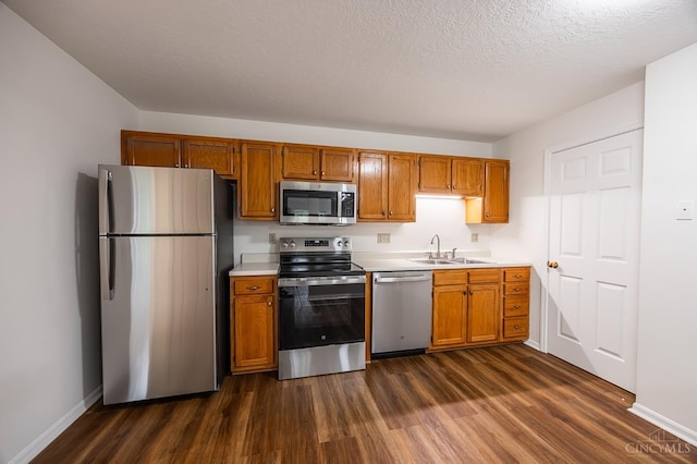 3721 W Galbraith Rd Unit A-2, Cincinnati, OH 45247 - kitchen with appliances with stainless steel finishes, a sink, dark wood finished floors, light countertops, and baseboards