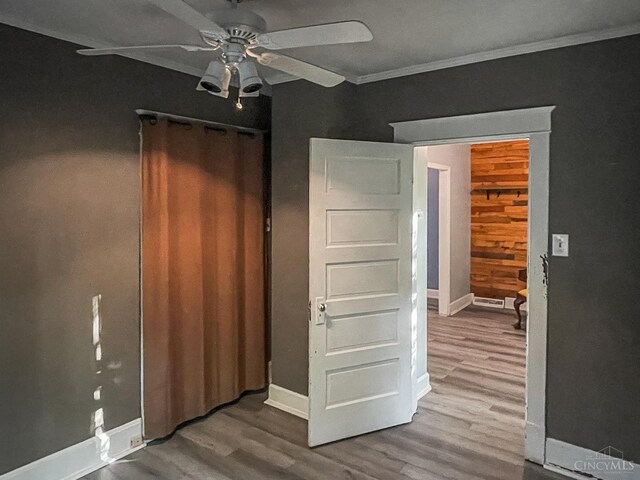 1588 Moon Valley Ln, Anderson Twp, OH 45230 - unfurnished bedroom with wood finished floors, ornamental molding, and ceiling fan