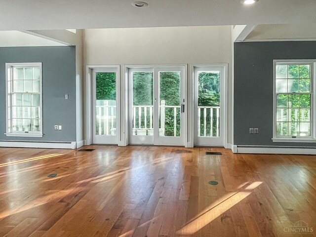 1588 Moon Valley Ln, Anderson Twp, OH 45230 - unfurnished living room featuring a baseboard radiator, wood finished floors, and crown molding