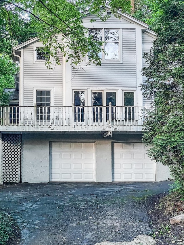 1588 Moon Valley Ln, Anderson Twp, OH 45230 - back of house with a garage and asphalt driveway