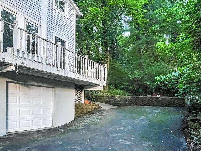 1588 Moon Valley Ln, Anderson Twp, OH 45230 - view of side of property featuring a garage and a balcony