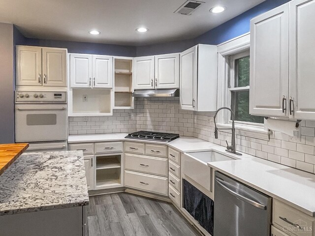 1588 Moon Valley Ln, Anderson Twp, OH 45230 - kitchen with appliances with stainless steel finishes, open shelves, light countertops, recessed lighting, and wood finished floors