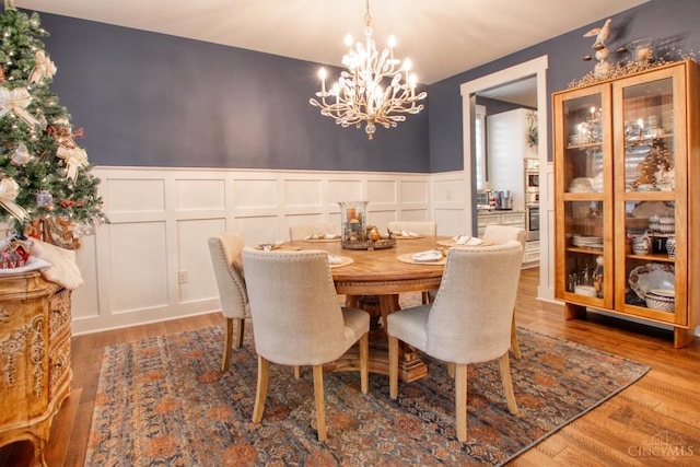 2645 Autumn Harvest Dr, Deerfield Twp, OH 45140 - dining space featuring a decorative wall, a chandelier, wainscoting, and wood finished floors