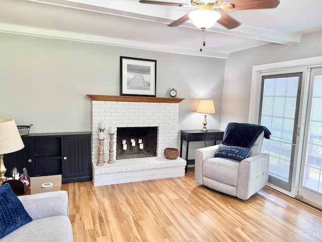 4375 Airycrest Ln, Cincinnati, OH 45211 - living area featuring wood finished floors, ceiling fan, beamed ceiling, a brick fireplace, and crown molding