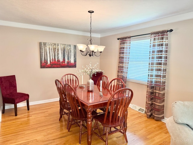 4375 Airycrest Ln, Cincinnati, OH 45211 - dining area with light wood finished floors, a chandelier, and crown molding