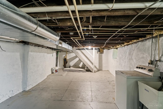 2266 Loth St, Cincinnati, OH 45219 - unfinished below grade area with washer / clothes dryer and a sink