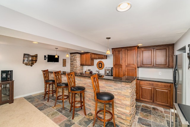 5200 Poets Way, Liberty Twp, OH 45011 - kitchen with stone tile floors, decorative light fixtures, fridge, and recessed lighting