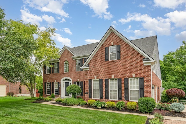 5200 Poets Way, Liberty Twp, OH 45011 - colonial-style house featuring brick siding, a front yard, and a shingled roof