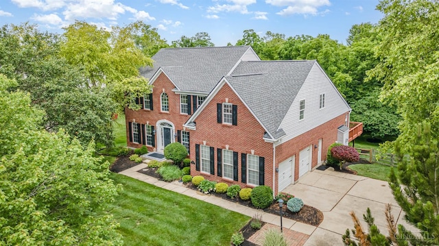 5200 Poets Way, Liberty Twp, OH 45011 - colonial home featuring brick siding, concrete driveway, an attached garage, and roof with shingles