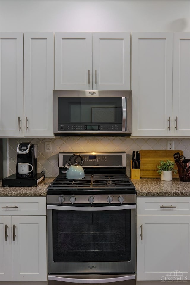 306 Mulberry St Unit 2, Cincinnati, OH 45202 - kitchen with stainless steel appliances, white cabinetry, decorative backsplash, and dark stone countertops